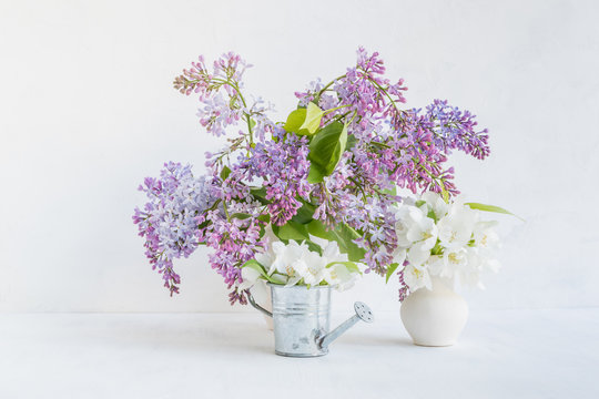 Bouquet of lilac in a vase on a light background