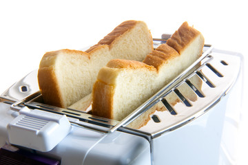 Toast in a toaster. Fried toast slices inside the toaster. A close-up view of pastries in a toasting device.