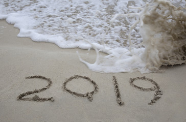 2019 written in the sand with wave