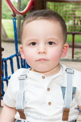 Cute young boy playing on playground