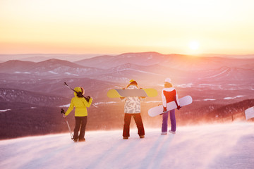 Friends at ski resort against sunset