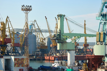 Fototapeta na wymiar Cargo terminal of international freight industrial port. Sea freight, cranes. Industrial port.