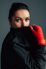 Close up portrait of a young sportswoman. Pretty female brunete boxer. Healthy lifestyle concept