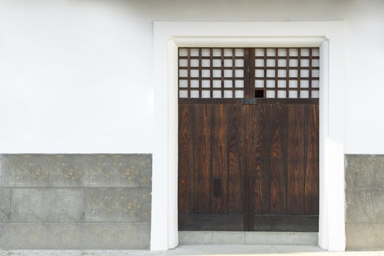 Traditional classic Japanese wood door or gate and stone wall in ancient japanese house, japan