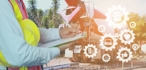 Engineer yellow helmet for the safety of workers on the background of Concrete Mixer Truck sites...