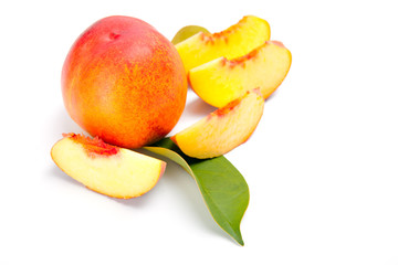 fresh peach fruits with green leaves isolated on white background