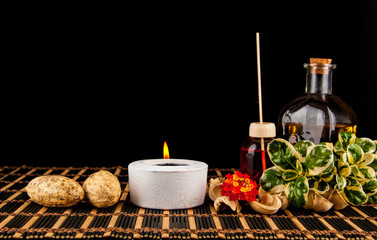 Essential aroma oil with flowers on black background. Selective focus