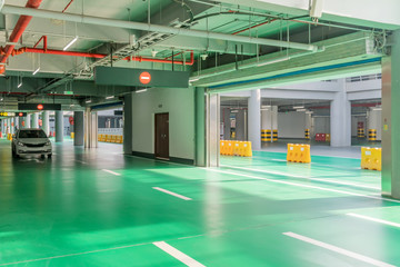 interior of parking garage with car and vacant parking lot in parking building
