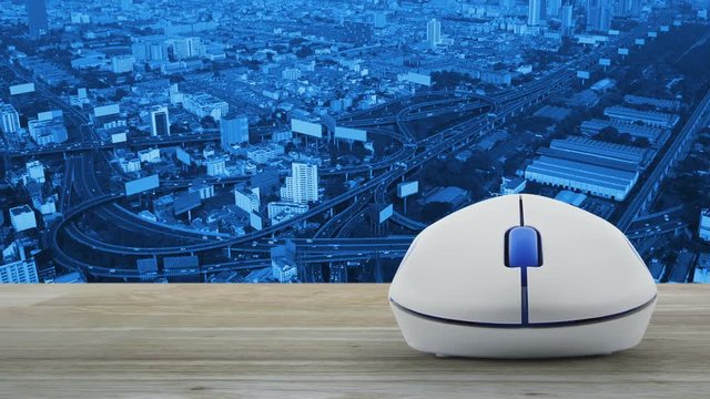 Restaurant cloche flat icon with wireless computer mouse on wooden table over city tower, street and expressway, Food delivery concept