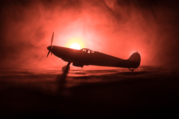 British jet-propelled model plane in possession. Dark orange fire background. War scene.