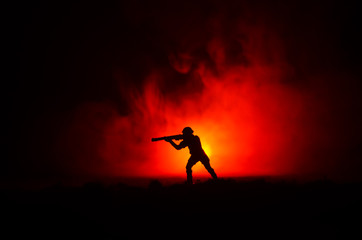 Battle scene soldier with riffle with bloody fire sky background