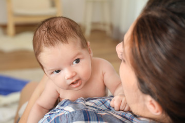 Young mother with cute baby at home