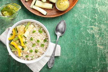 Bowl with brown rice and vegetables on table