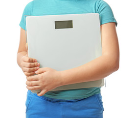 Overweight boy with scales on white background, closeup