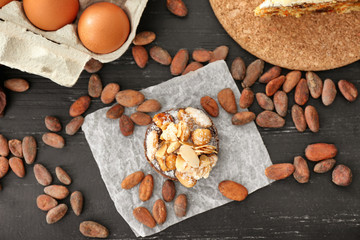 Composition with tasty praline cake on table