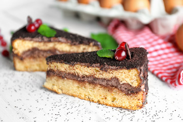 Pieces of tasty chocolate cake on wooden background