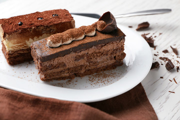 Plate with tasty chocolate cakes on table