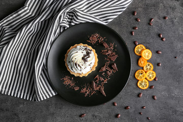 Plate with tasty tartlet on table