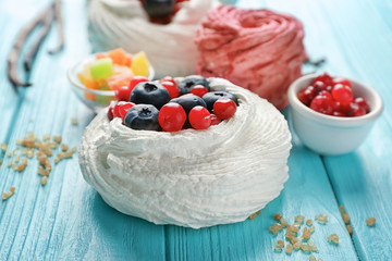 Tasty Pavlova cake on wooden table
