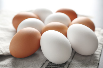 Raw chicken eggs on table