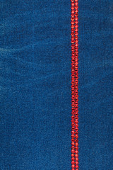 Line made of blue crystals on blue denim fabric. Luxurious, beautiful, fashionable background.