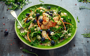 Fresh Chicken salad with Blueberries, feta, carrots, nuts and green vegetables. healthy food concept
