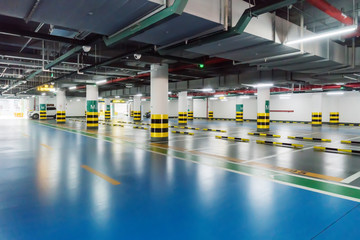 interior of parking garage with car and vacant parking lot in parking building