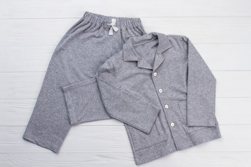 Sleepwear set on white background. Shirt and pants made of gray cotton fabric. Snugly fit and comfy...