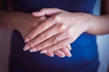 Elegant diamond ring on finger woman