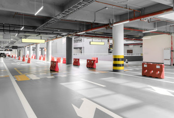 Fototapeta premium interior of parking garage with car and vacant parking lot in parking building