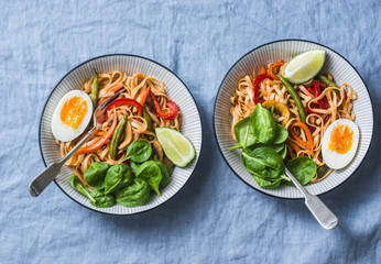 Yaki Udon noodles with stir fry vegetables, boiled egg and spinach. Vegetarian noodles with green...