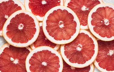 Food background. Cut fresh ripe grapefruit, top view, flat lay. Free space for text
