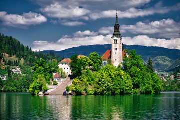 Bled lake with church island and mountains in background.