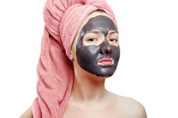 beautiful sexy girl with black face mask on the white background,  close-up portrait, isolated, girl with a pink towel on her head, seriously looks at the camera, black mask on girl's face, enjoys