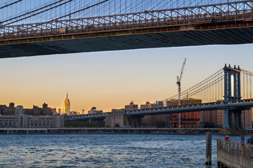 Fototapeta na wymiar Manhattan bridge and New York city center on the sunset lights