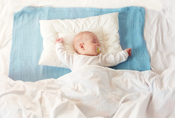 baby sleeping on blue blanket