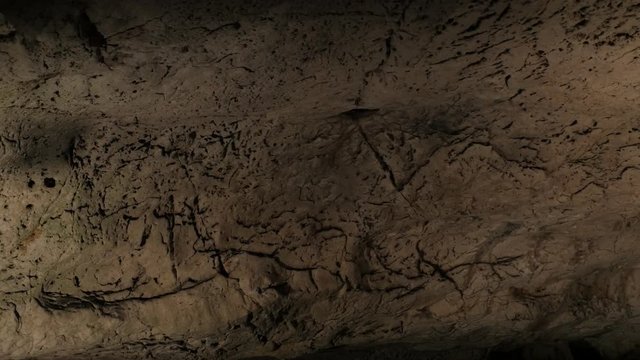 Wall of area deep inside underground cavern footage - Slow pan on ancient cave formations 