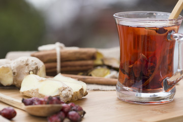 Healthy herbal tea,  spiced tea over wood background 
