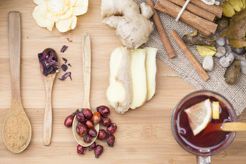 Healthy herbal tea,  spiced tea over wood background 