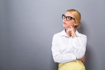 Young woman in a thoughtful pose on a solid background