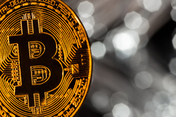 Bitcoin gold coins with defocused abstract background. Virtual cryptocurrency concept.