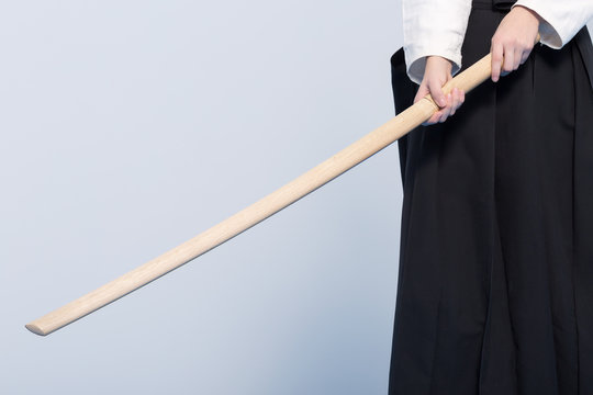 Hands holding a wooden sword bokken