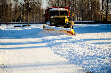 Snow plow truck workiyng in a city park