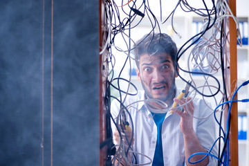 Computer repairman working on repairing network in IT workshop