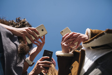 Group of friends in the street with smartphone