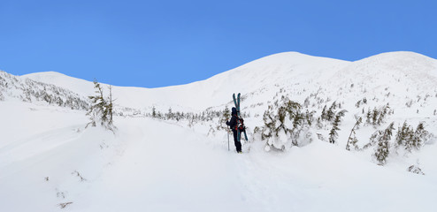 Fototapeta na wymiar Alpine touring skier in winter mountains.