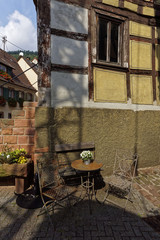 chair and table in front of the house in summer