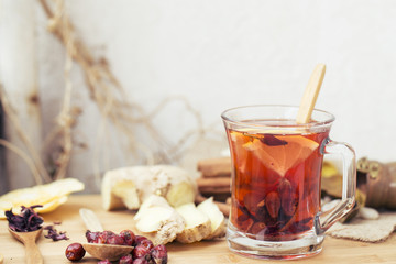 Healthy herbal tea,  spiced tea over wood background 