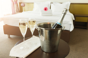 Two glasses and bottle of champagne in hotel