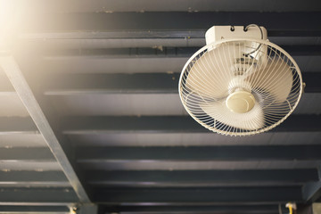 Old fan hanging on the roof with flare